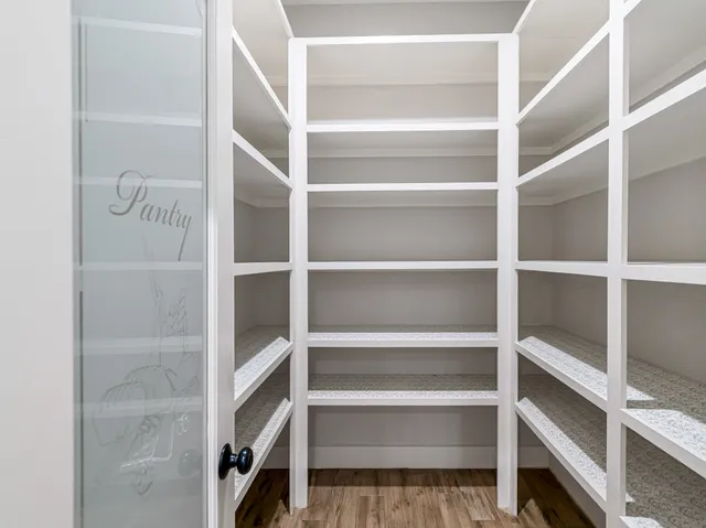 a view of walk in closet with empty racks