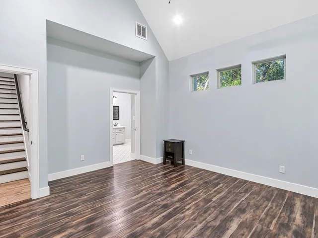 a view of empty room with wooden floor