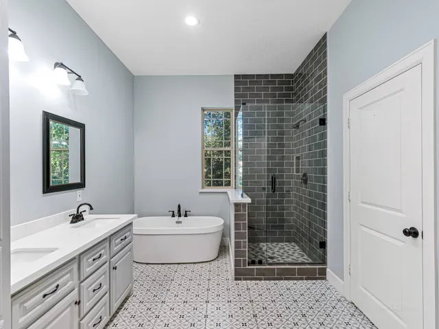 a bathroom with a double vanity sink a toilet a mirror and shower