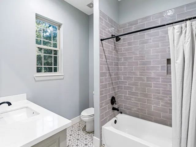 a bathroom with a toilet and a bathtub