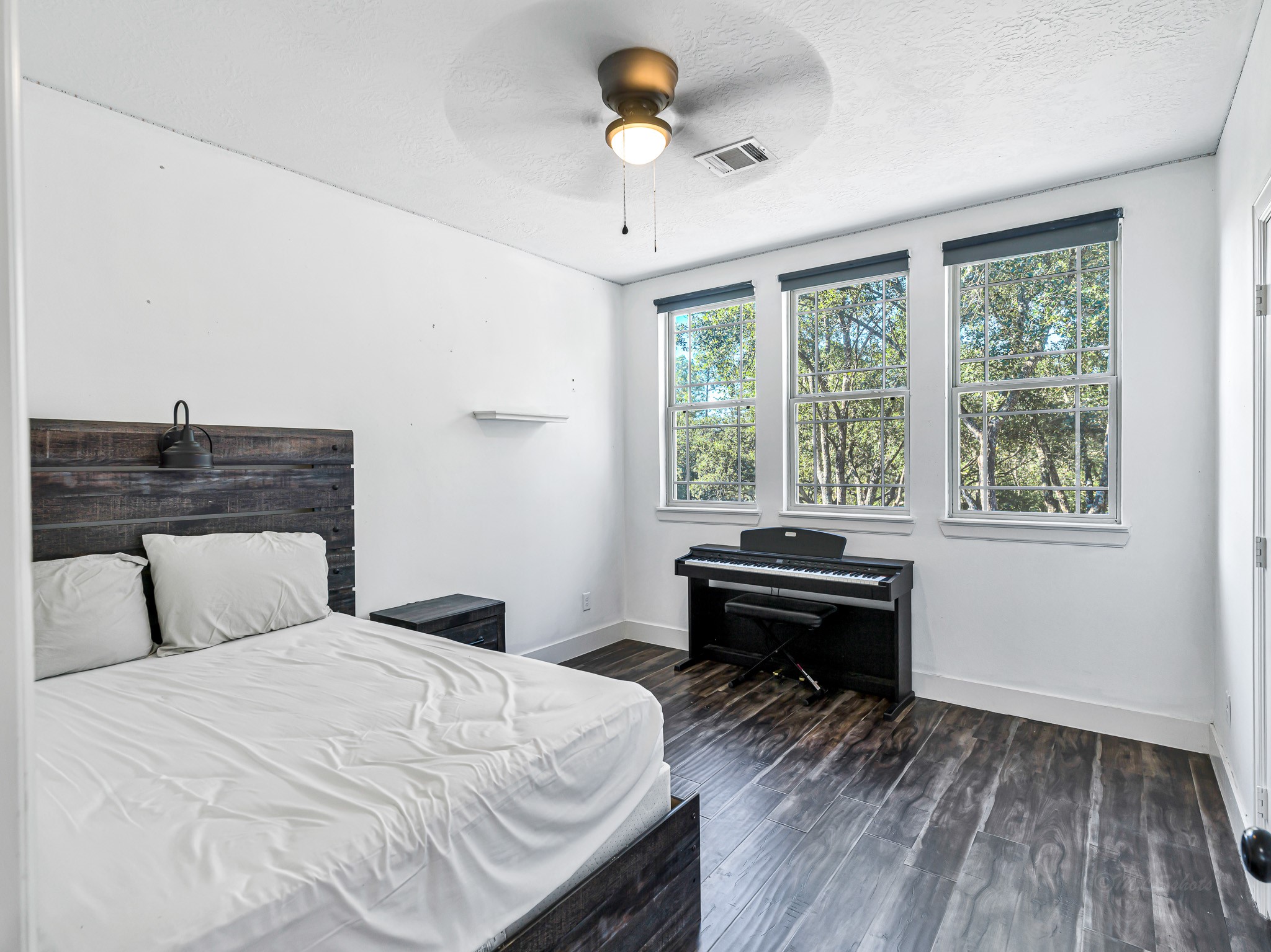 18117 FM 762 Road Needville, TX 77461 - Photo 23 of 37 a bedroom with a bed and a chandelier