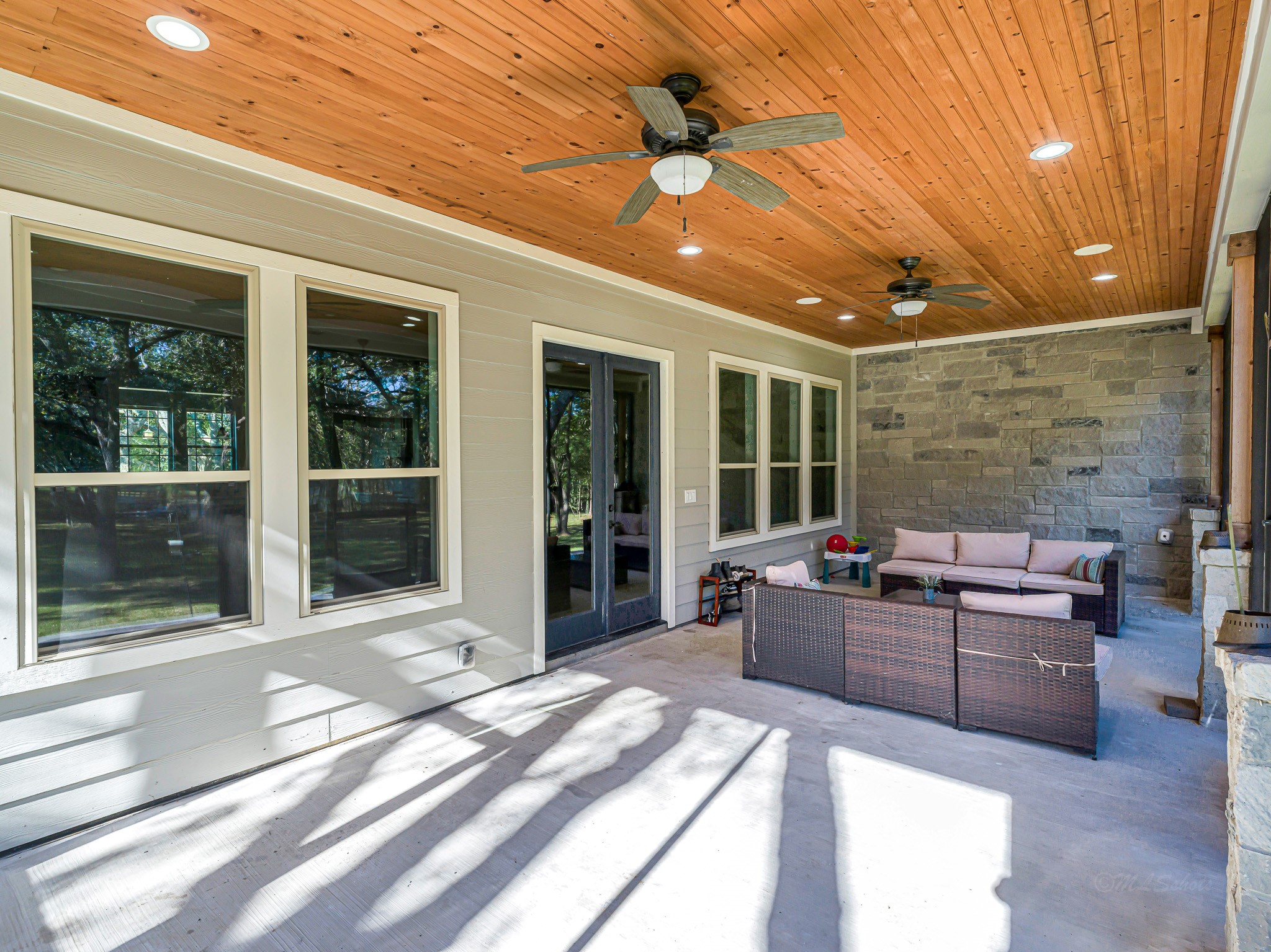 18117 FM 762 Road Needville, TX 77461 - Photo 28 of 37 a living room with furniture a flat screen tv and a floor to ceiling window