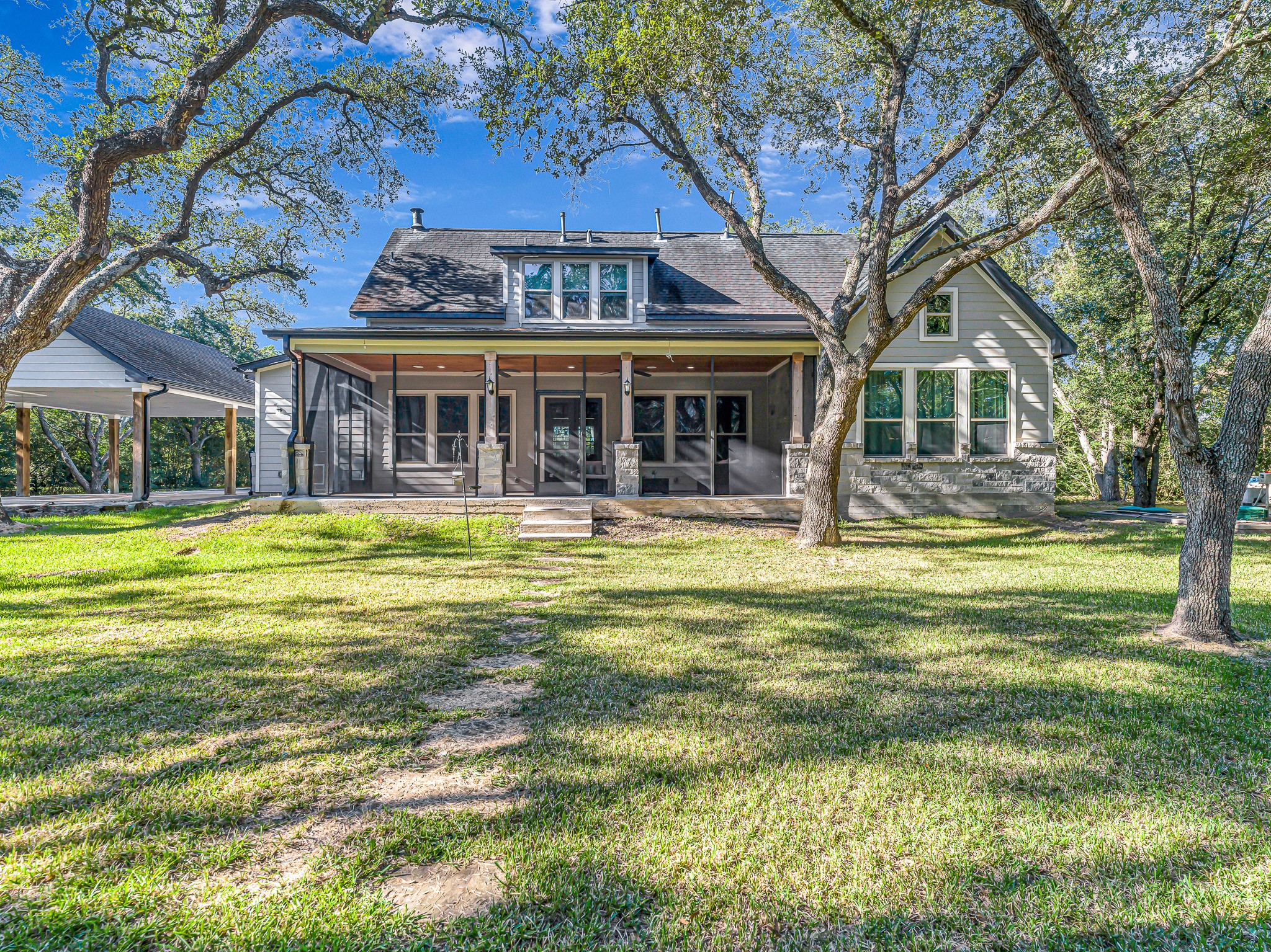 18117 FM 762 Road Needville, TX 77461 - Photo 33 of 37 a front view of a house with swimming pool and garden