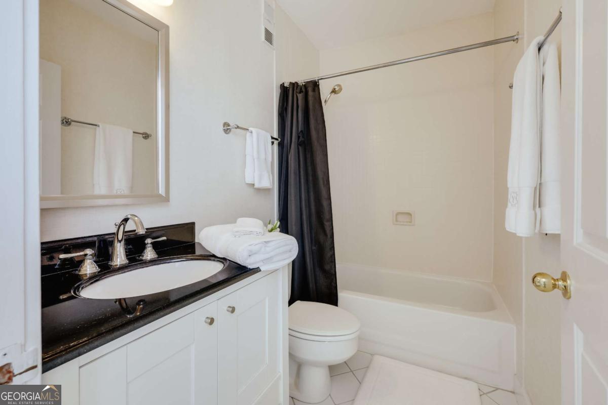 247 West Washington Street, Unit 504 Athens, GA 30601 - Photo 17 of 34 a bathroom with a granite countertop sink toilet and shower