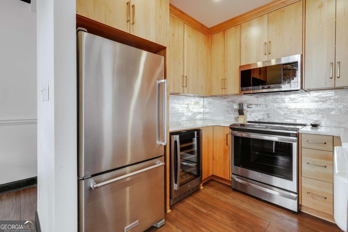 247 West Washington Street, Unit 504 Athens, GA 30601 - Photo 7 of 34 a kitchen with stainless steel appliances a refrigerator stove and microwave