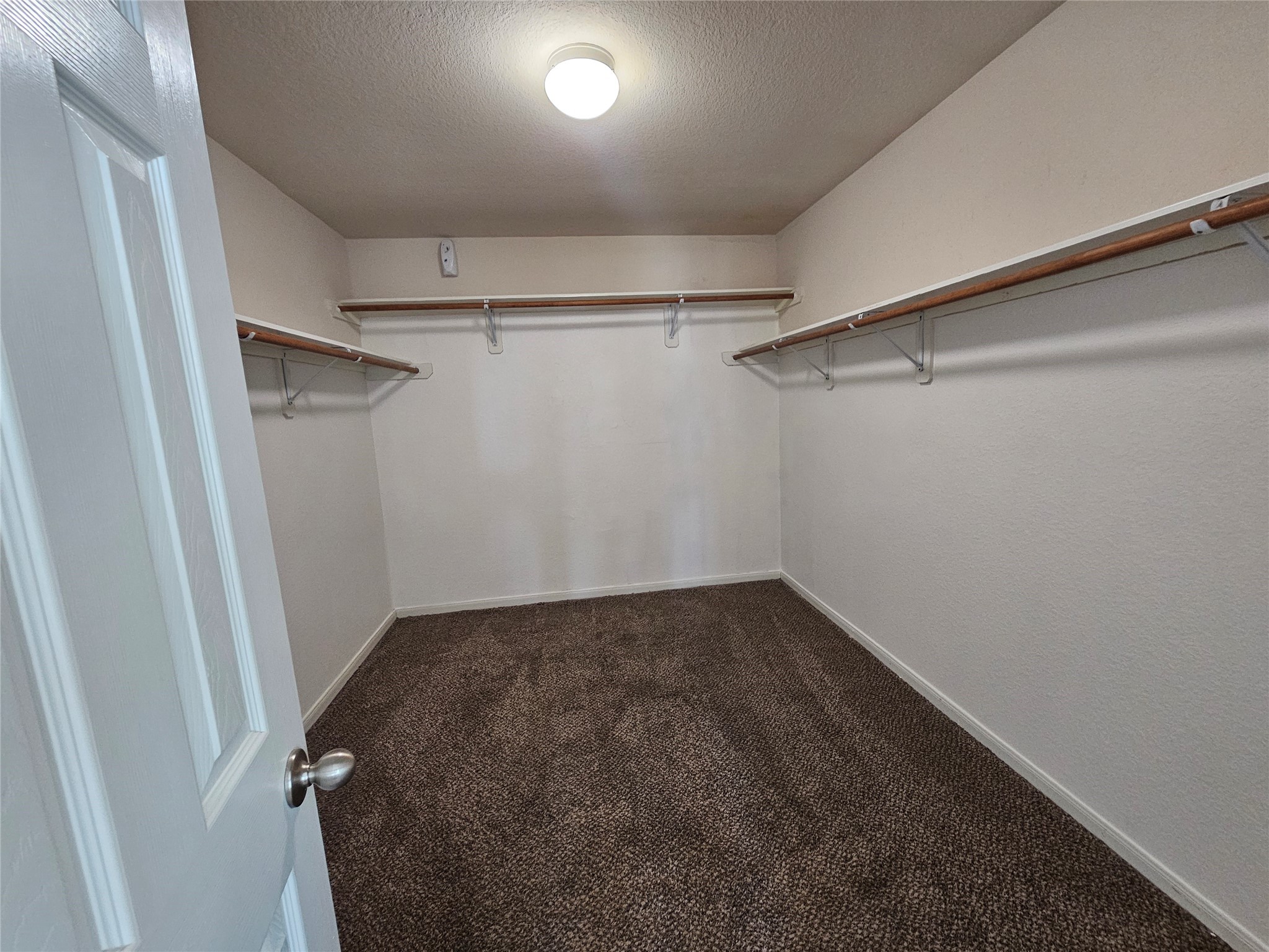 13231 Barrow Point Lane Houston, TX 77014 - Photo 14 of 27 a view of a room with racks on the wall