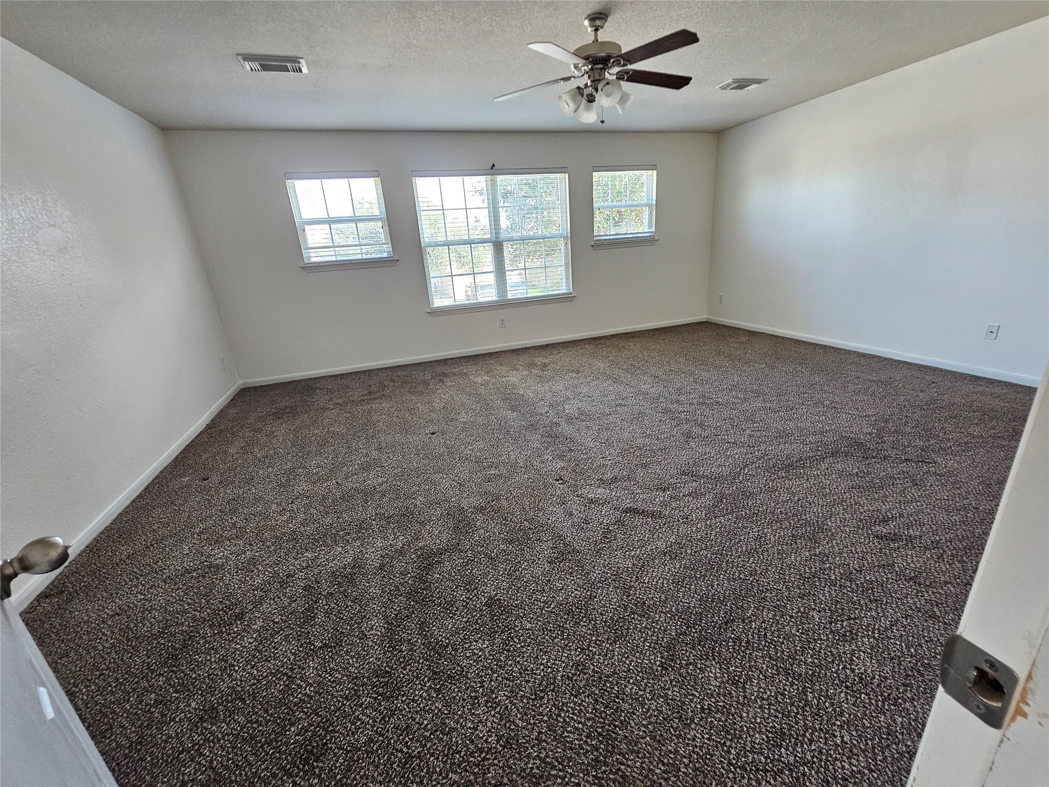 13231 Barrow Point Lane Houston, TX 77014 - Photo 15 of 27 an empty room with windows and fan