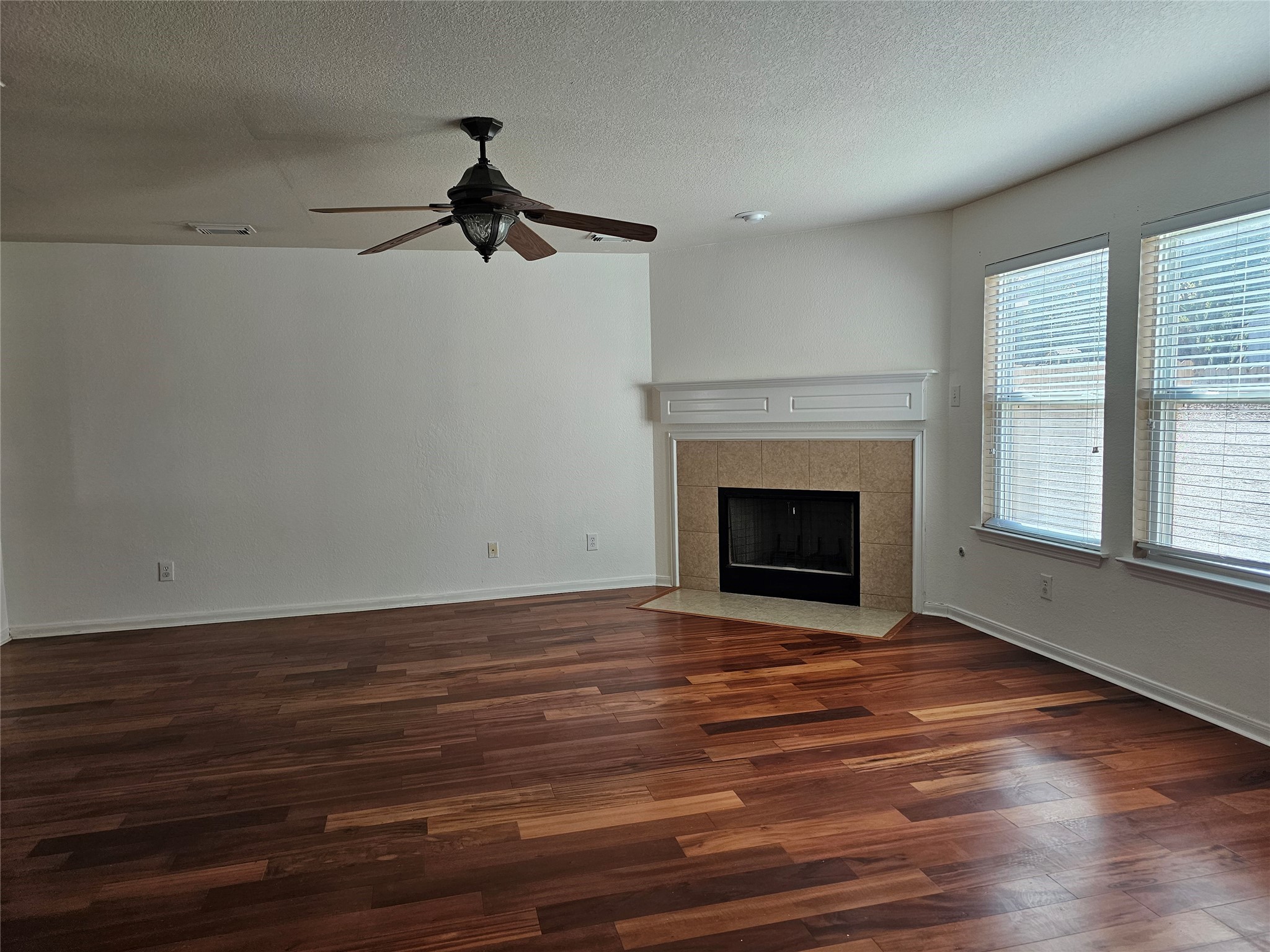 13231 Barrow Point Lane Houston, TX 77014 - Photo 5 of 27 a view of an empty room with wooden floor fireplace and a window
