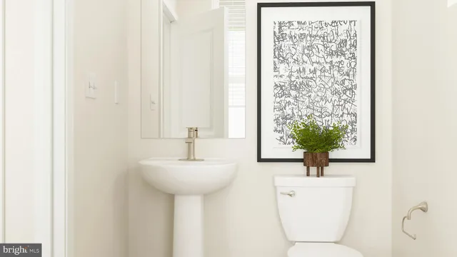 a room with a toilet sink and mirror