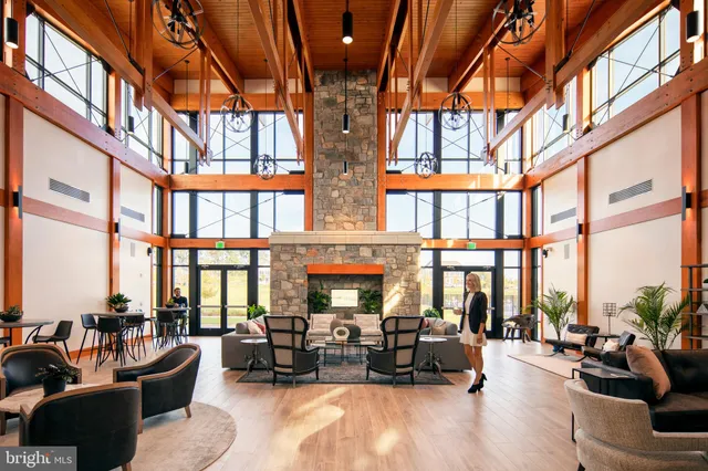 a living room with furniture and floor to ceiling windows