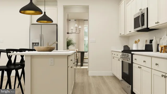 a kitchen with stainless steel appliances granite countertop a stove a refrigerator and a cabinets