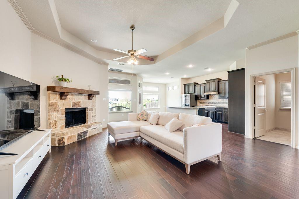 a living room with furniture wooden floor and a fireplace