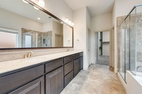 a spacious bathroom with a double vanity sink mirror and double