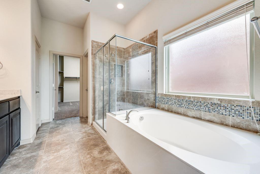 9641 Calaveras Road Fort Worth, TX 76177 - Photo 13 of 23 a spacious bathroom with a bathtub and a shower
