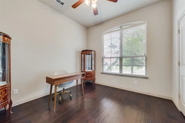 a view of a workspace with furniture and a window