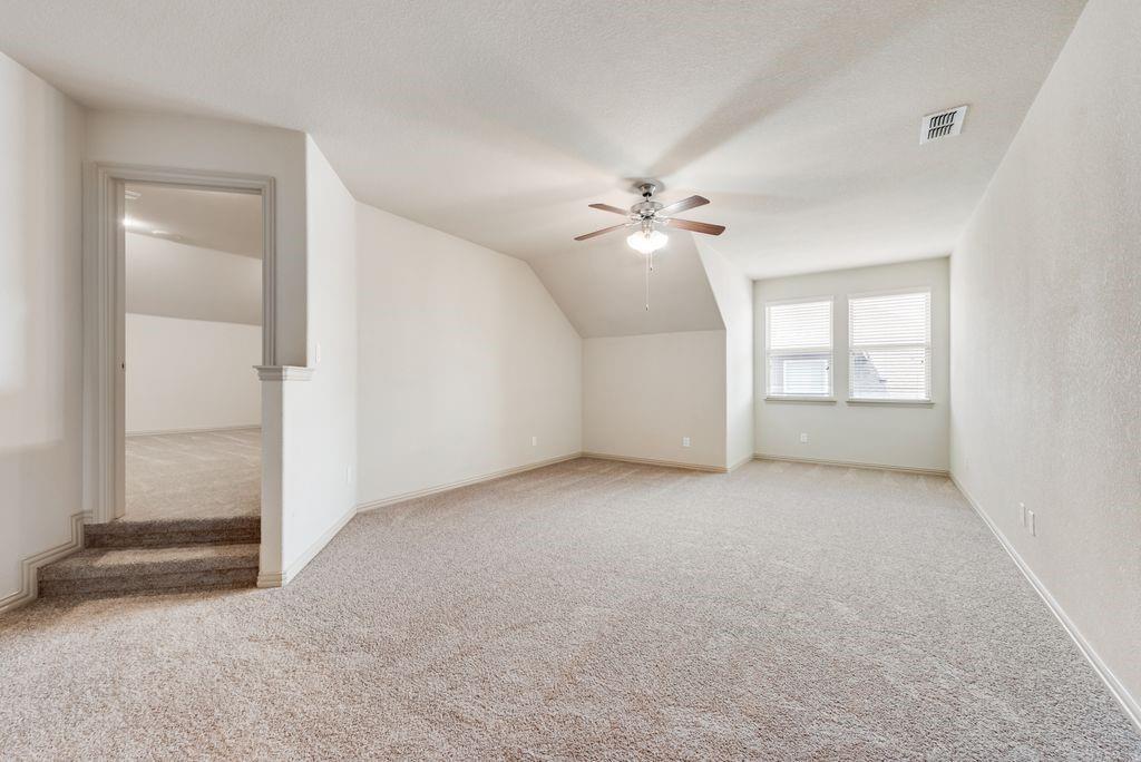 9641 Calaveras Road Fort Worth, TX 76177 - Photo 18 of 23 an empty room with chandelier fan and windows