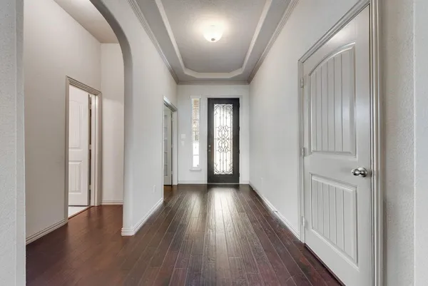 a view of a hallway with wooden floor