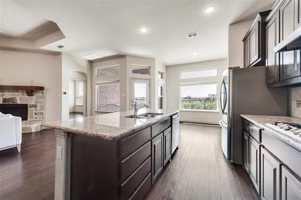 a kitchen with stainless steel appliances granite countertop a stove and a refrigerator