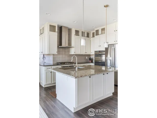 a kitchen with stainless steel appliances granite countertop a sink and a stove