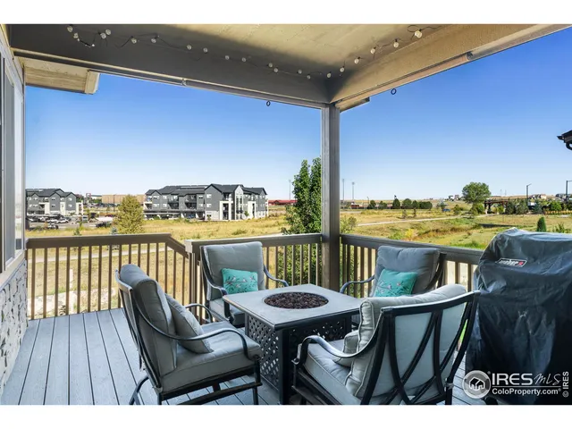 a balcony with chairs and wooden floor
