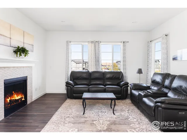 a living room with furniture a fireplace with wooden floor