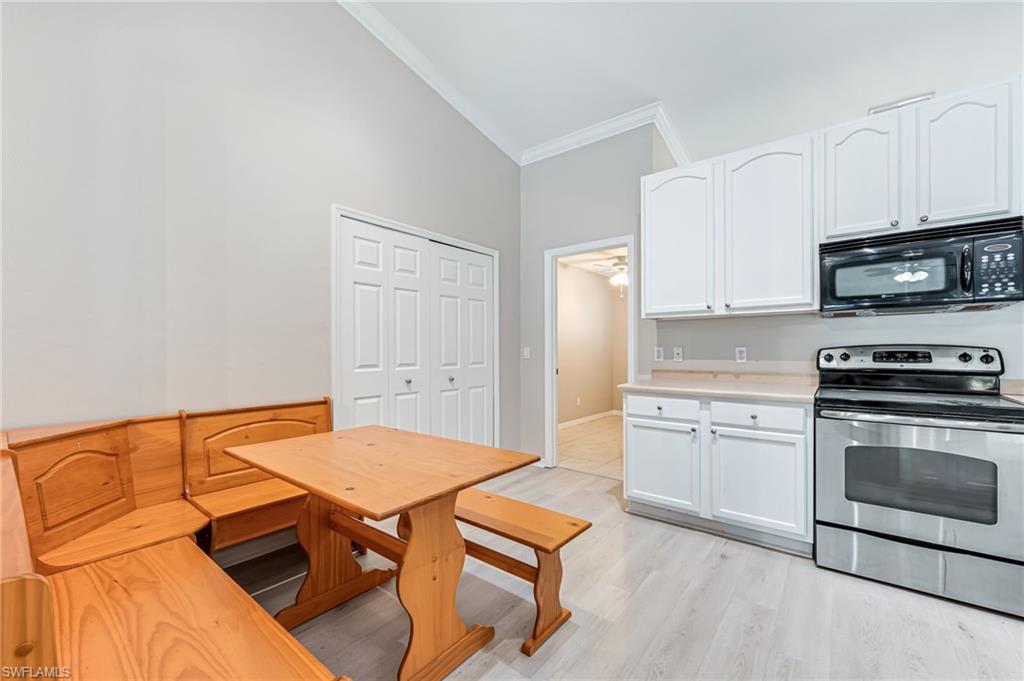 3630 10th Avenue Southeast Naples, FL 34117 - Photo 16 of 50 a kitchen with a stove and a microwave