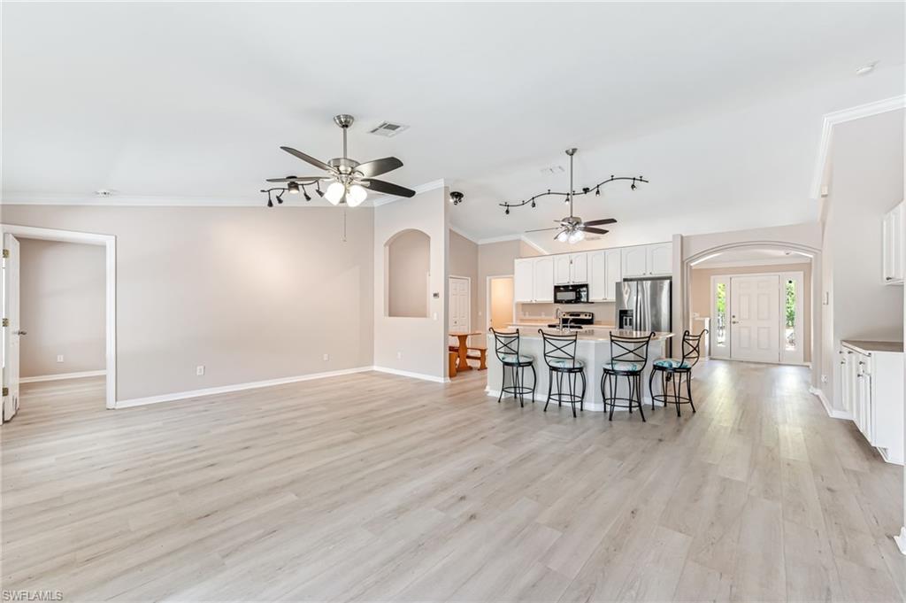 3630 10th Avenue Southeast Naples, FL 34117 - Photo 19 of 50 a view of a dining room with furniture and wooden floor