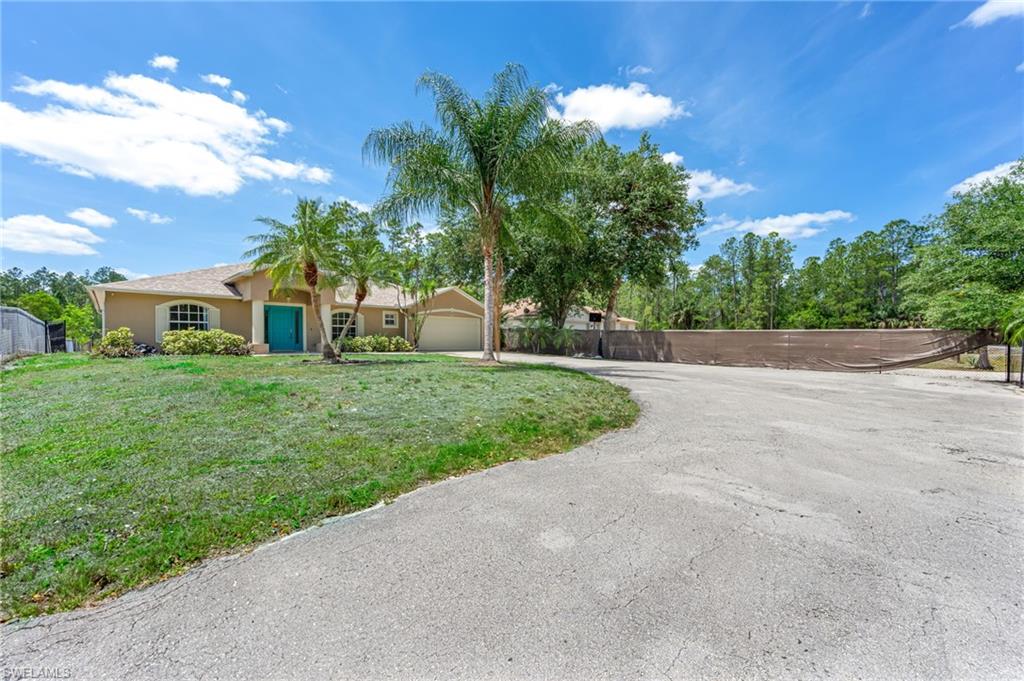 3630 10th Avenue Southeast Naples, FL 34117 - Photo 2 of 50 a view of a house with a big yard