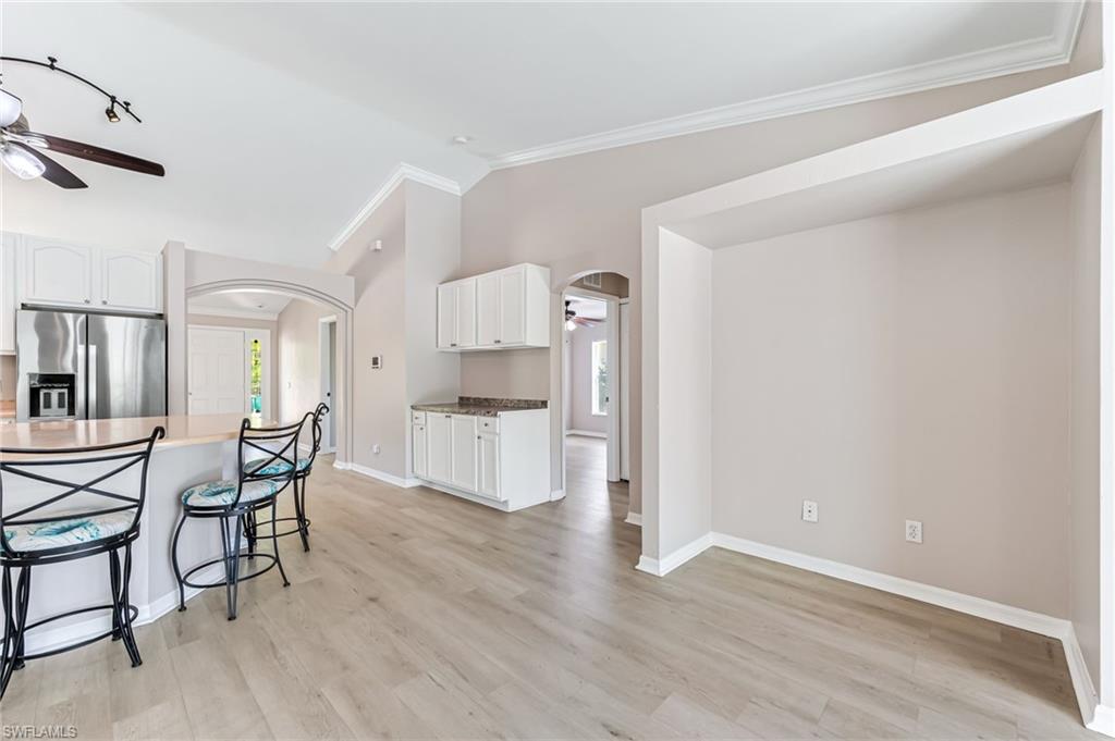 3630 10th Avenue Southeast Naples, FL 34117 - Photo 22 of 50 a view of a dining room with furniture and wooden floor