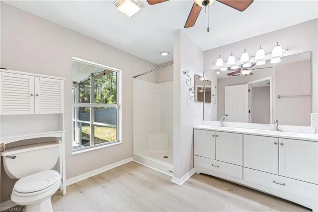 a spacious bathroom with a toilet sink and mirror
