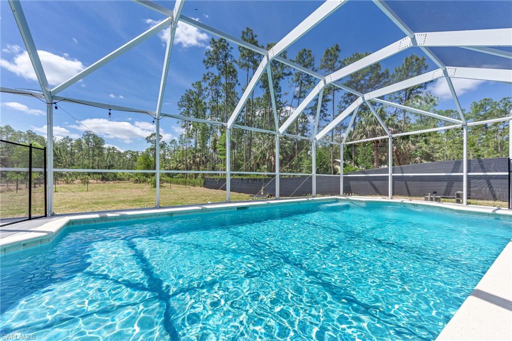 3630 10th Avenue Southeast Naples, FL 34117 - Photo 41 of 50 a view of a backyard with swimming pool