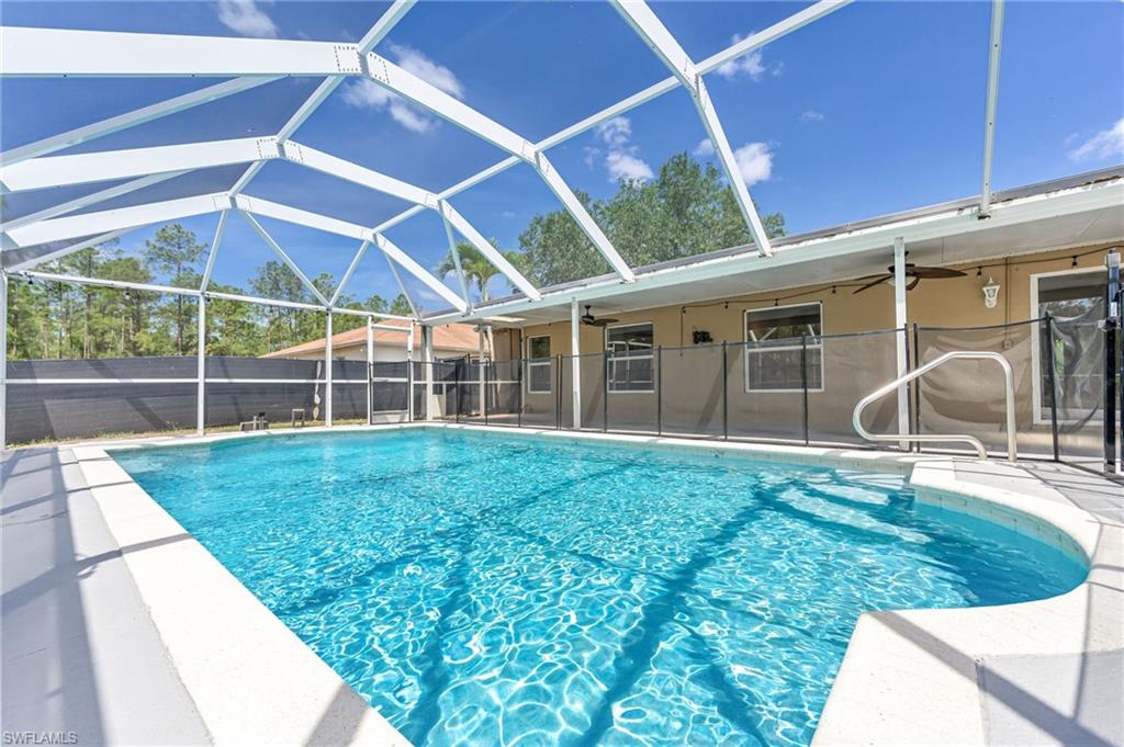 3630 10th Avenue Southeast Naples, FL 34117 - Photo 43 of 50 a view of a backyard with table and chairs