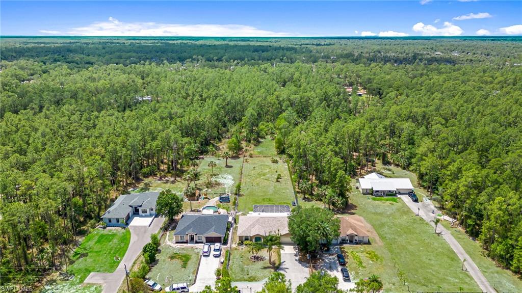 3630 10th Avenue Southeast Naples, FL 34117 - Photo 48 of 50 an aerial view of residential houses with outdoor space and trees