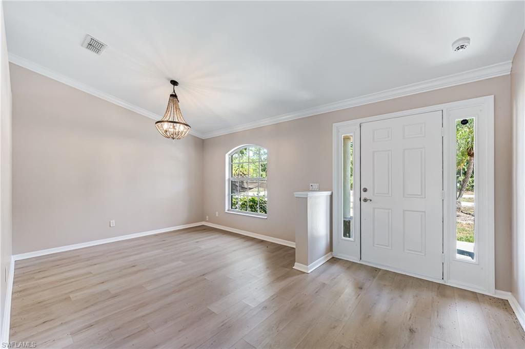 3630 10th Avenue Southeast Naples, FL 34117 - Photo 5 of 50 an empty room with wooden floor and windows