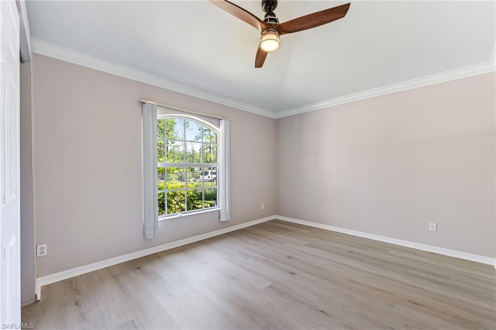 3630 10th Avenue Southeast Naples, FL 34117 - Photo 7 of 50 wooden floor in an empty room with a window