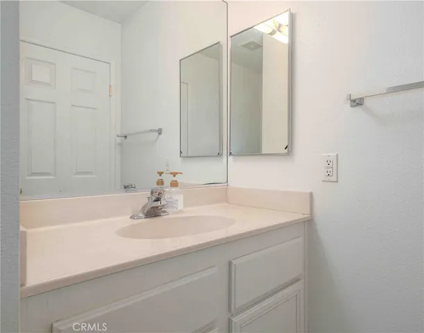 a view of empty room with wooden floor and window