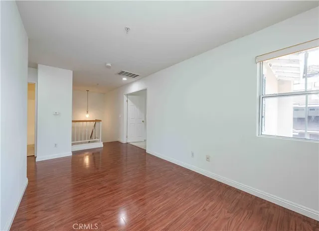 an empty room with windows and closet