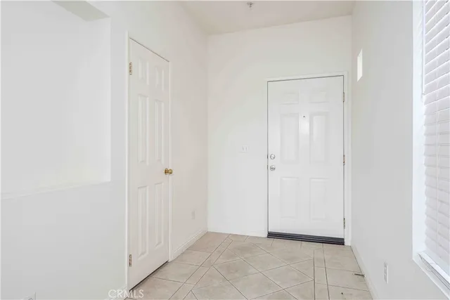 a view of empty room with wooden floor and fireplace