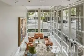 a living room with furniture and a floor to ceiling window