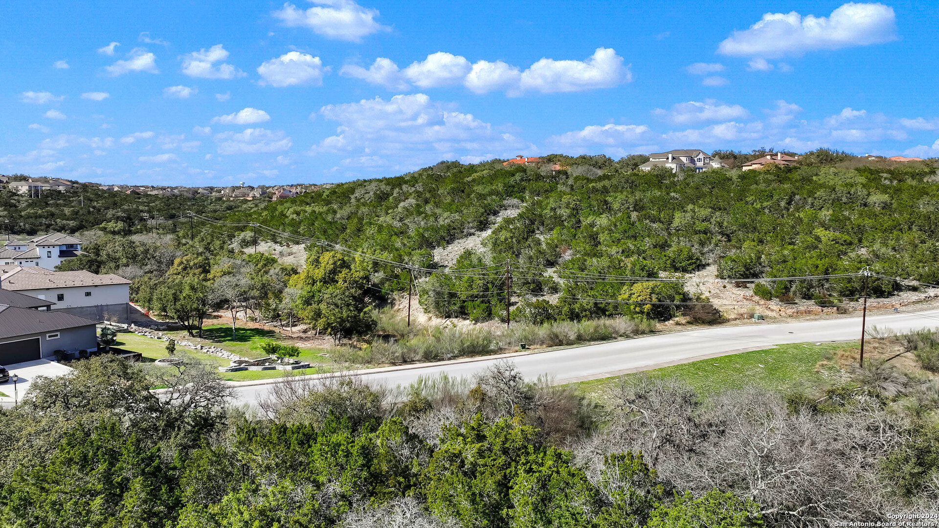 602 Winding Ravine San Antonio, TX 78258 - Photo 12 of 16 a view of a yard with plants and a houses