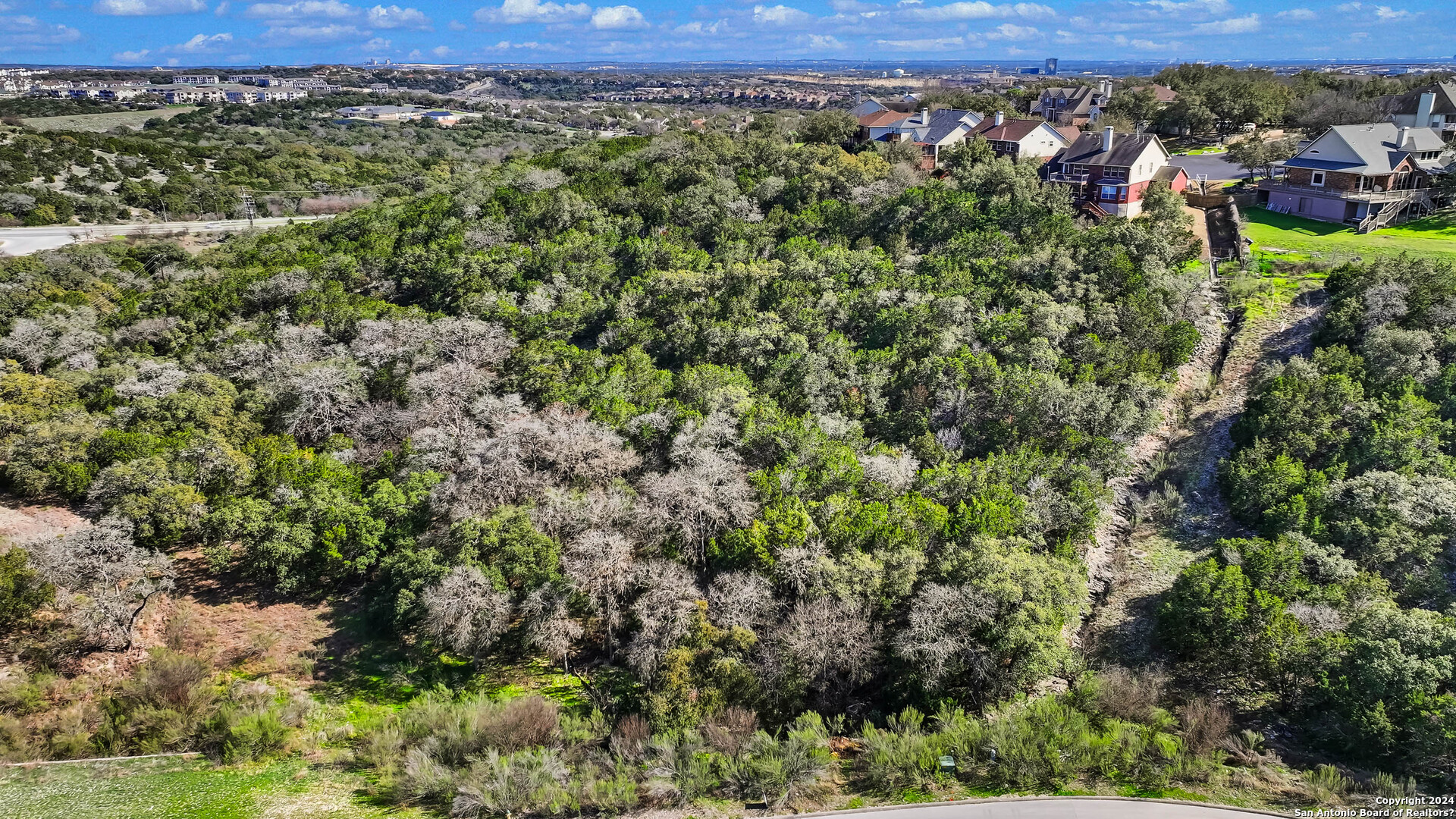 602 Winding Ravine San Antonio, TX 78258 - Photo 6 of 16 an aerial view of a houses with a yard