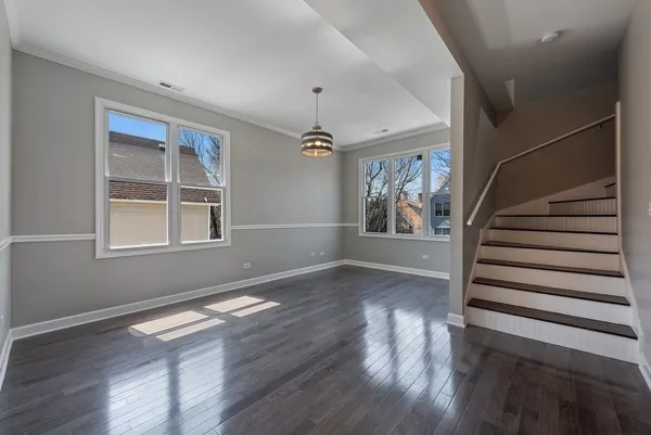a view of an entryway with wooden floor and windows