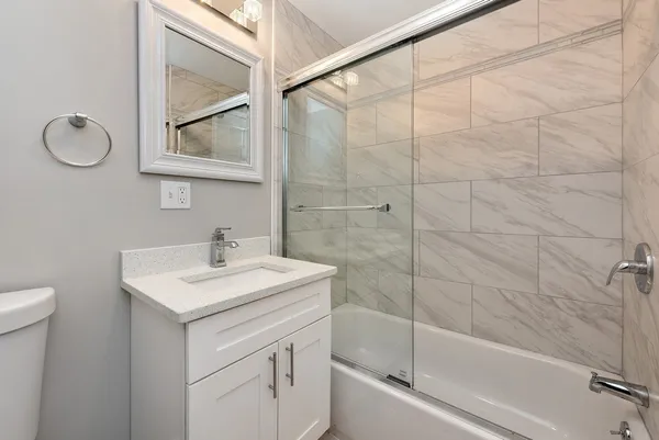 a bathroom with a sink toilet and shower
