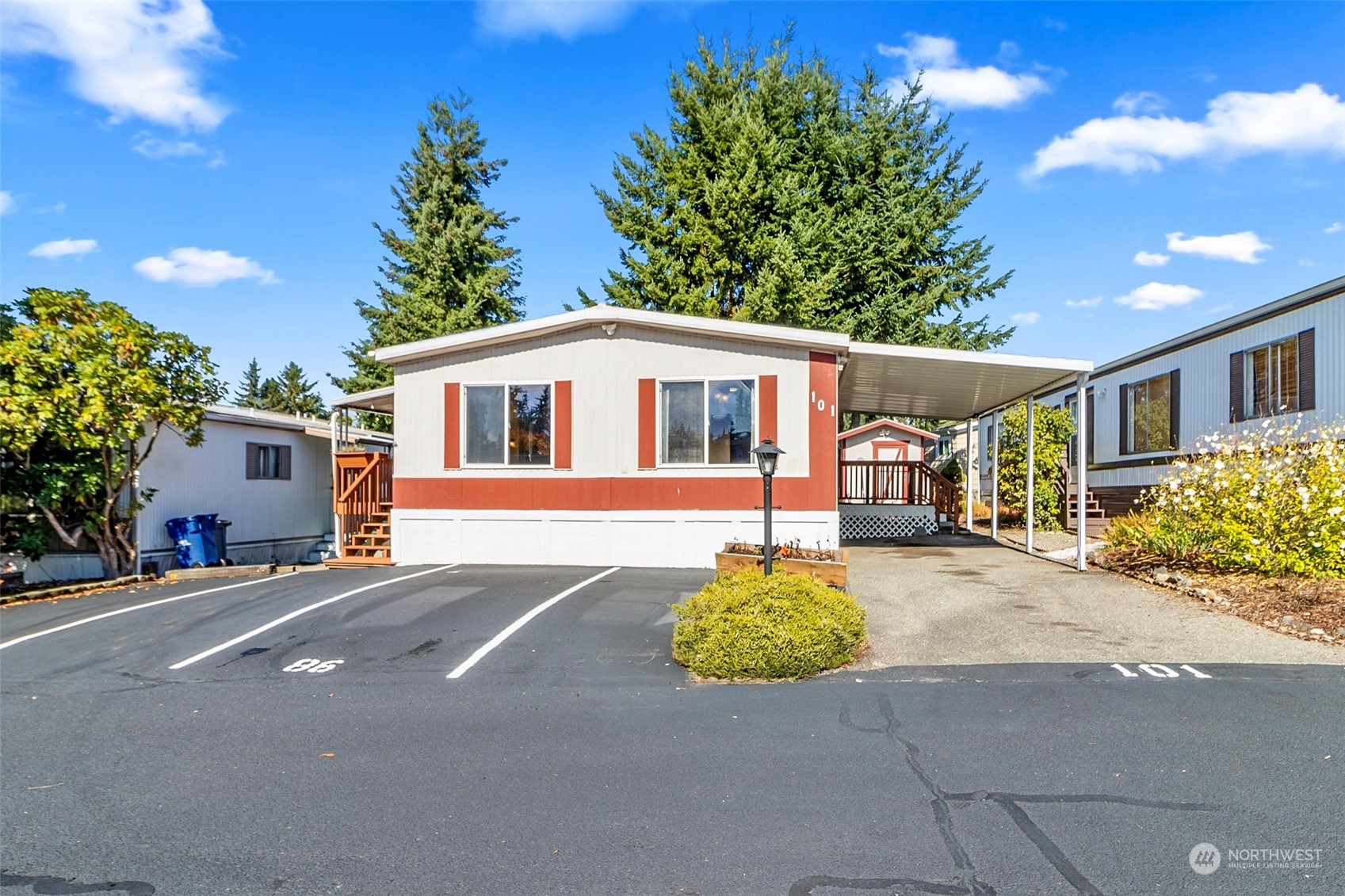 11622 Silver Lake Road, Unit 101 Everett, WA 98208 - Photo 1 of 40 a front view of a house with a yard and potted plants