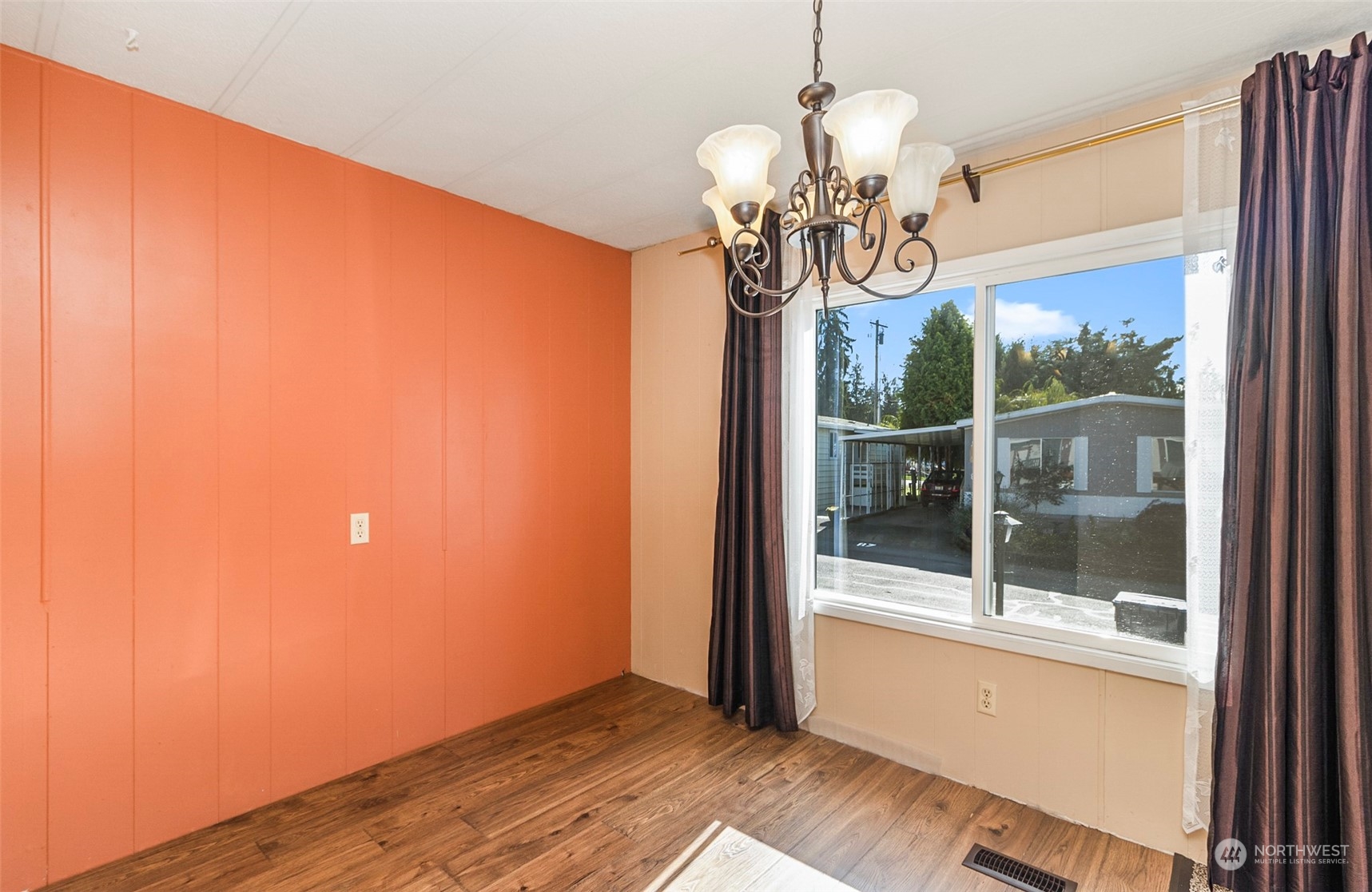11622 Silver Lake Road, Unit 101 Everett, WA 98208 - Photo 13 of 40 a view of a room with wooden floor and chandelier