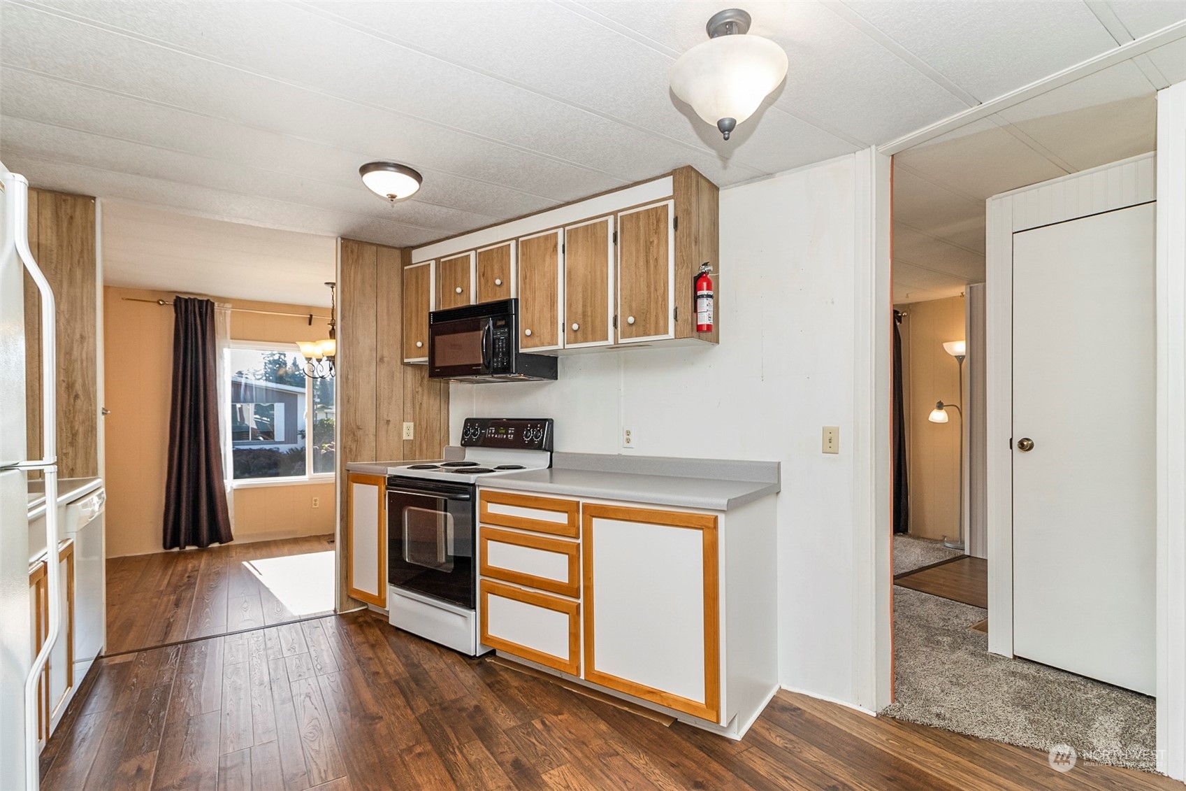 11622 Silver Lake Road, Unit 101 Everett, WA 98208 - Photo 24 of 40 a kitchen with stainless steel appliances granite countertop a refrigerator a stove top oven a sink and dishwasher with wooden floor
