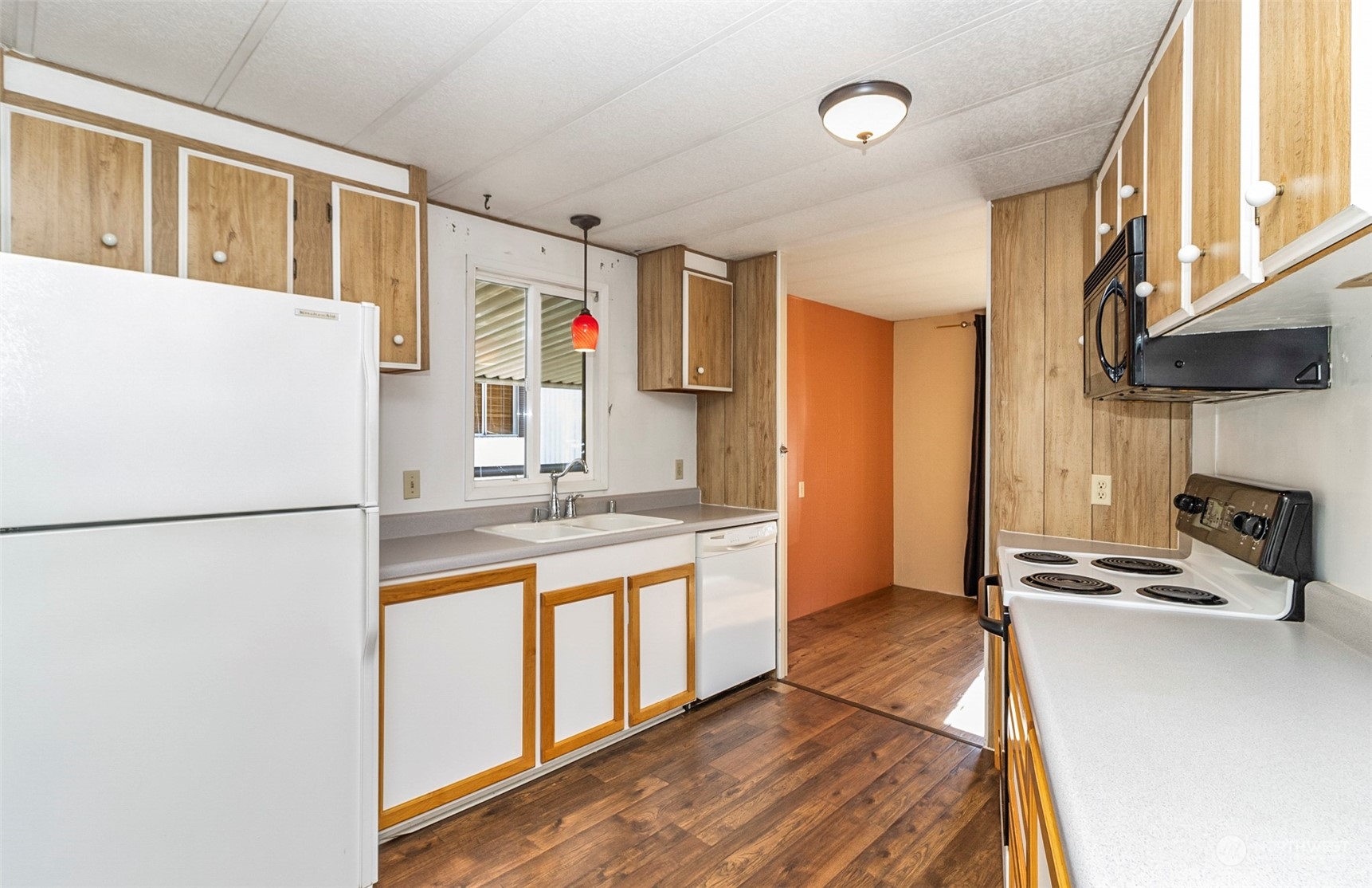 11622 Silver Lake Road, Unit 101 Everett, WA 98208 - Photo 25 of 40 a kitchen with stainless steel appliances a refrigerator sink and white cabinets