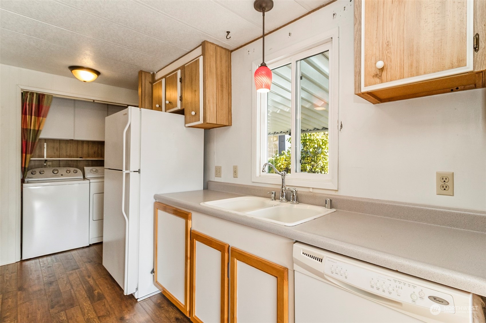 11622 Silver Lake Road, Unit 101 Everett, WA 98208 - Photo 28 of 40 a kitchen with a refrigerator a sink and cabinets