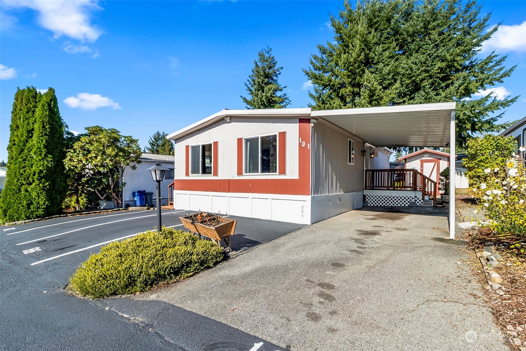 11622 Silver Lake Road, Unit 101 Everett, WA 98208 - Photo 4 of 40 a front view of a house with a yard and garage