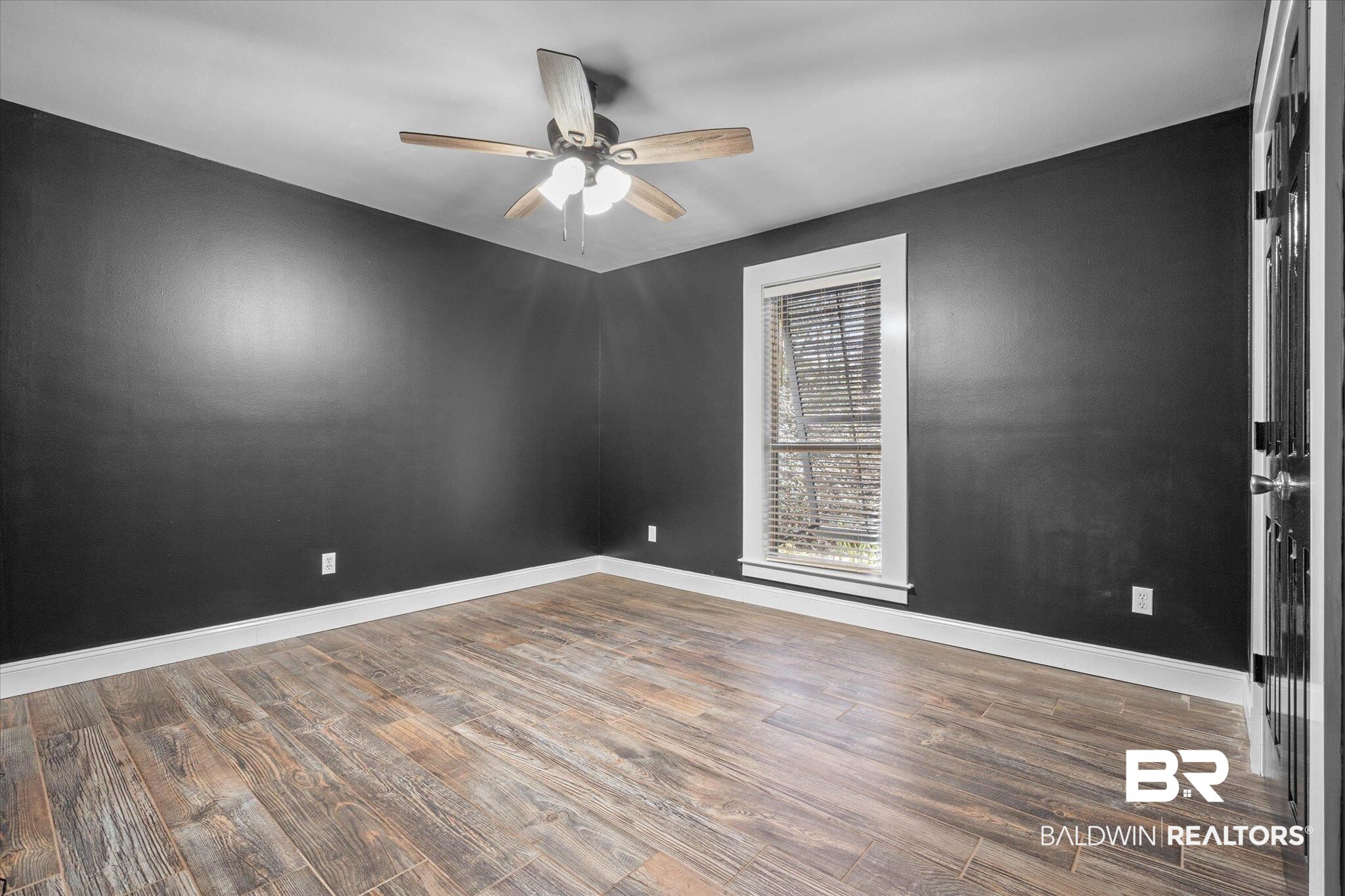 3216 Bay Booster Club Road Theodore, AL 36582 - Photo 19 of 46 Empty room with dark wood-type flooring and a ceiling fan